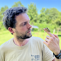 Dr Christoph Liedtke holding a frog on his finger